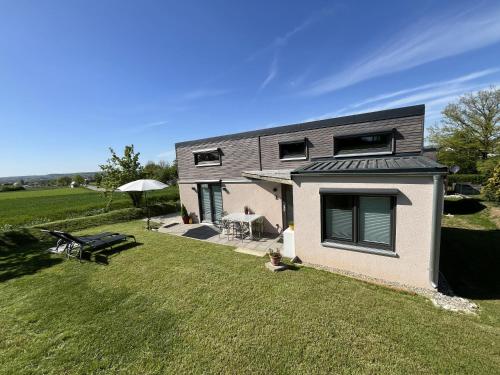 a house with a large yard with a grass field at Tinyhaus Ferien in Eggolsheim