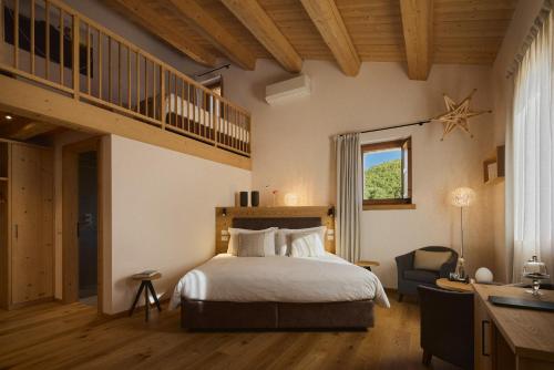 a bedroom with a large bed and a staircase at Aura Relais in Urbino