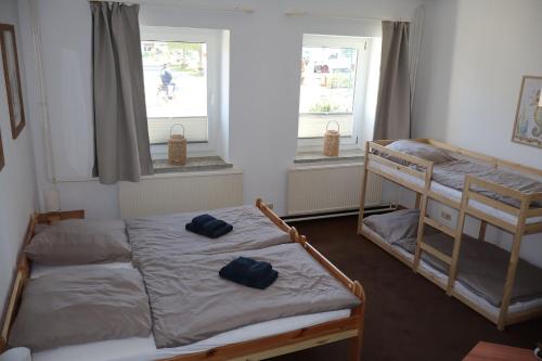 two bunk beds in a room with two windows at Möwennest Zempin in Zempin
