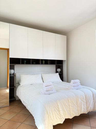 a bedroom with a large white bed with white cabinets at Etna Terrace Casa Lidia in Gaggi