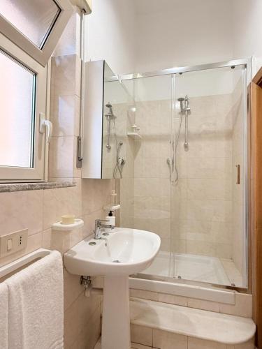 a white bathroom with a sink and a shower at Etna Terrace Casa Lidia in Gaggi
