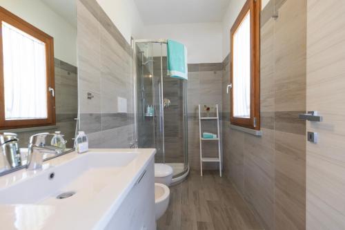a bathroom with a sink and a shower and a toilet at Casa Martina by ElbaSummer in Lacona