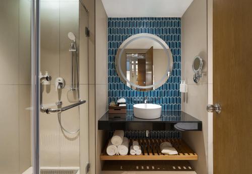 a bathroom with a sink and a mirror at Marigold Hotel in Hyderabad