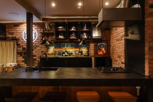a kitchen with a counter and a brick wall at Cellar 88 in Sonogi