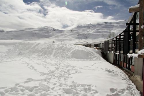 a pile of snow next to a fence at Studio 4 pers pieds des pistes Piau-engaly in Aragnouet