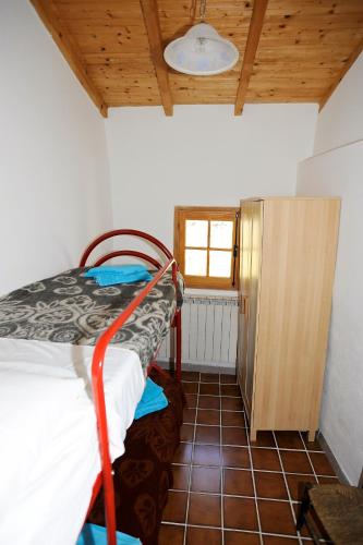 a bedroom with a bunk bed in a room with a window at Panoramic Apartment with Balcony and Terrace in Pigna