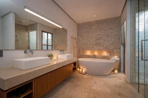 a bathroom with two sinks and a tub and a mirror at Grand garden villa Free Airport Pickup from 7 days in Phuket