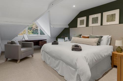 a bedroom with a large white bed and a desk at The Courtyard in Exeter