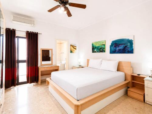 a bedroom with a bed and a ceiling fan at The Horizon - Sea View 8 in Sliema