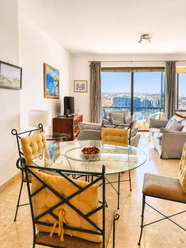 a living room with a glass table and chairs at The Horizon - Sea View 8 in Sliema