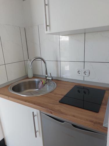 a small kitchen with a sink and a counter at Apartmani Sunset in Neum