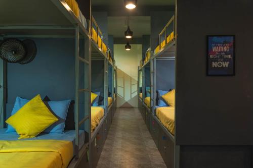 a hallway with four bunk beds in a room at TriboRoots Hostel in Anjuna