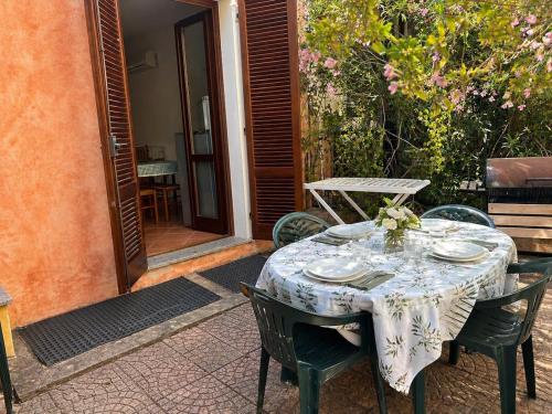 a table with plates on it on a patio at Villa Pinta - Key to Villas in Codaruina