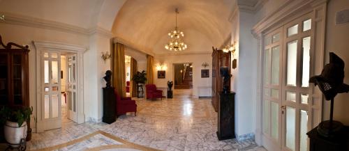 a hallway of a building with a chandelier at Villa Angelina in Massa Lubrense