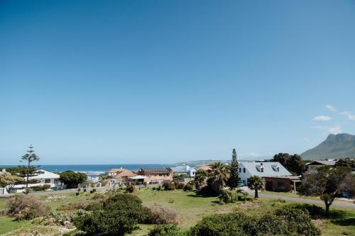 a suburb with houses and the ocean in the background at Shores Keep - Self Catering Home in Hermanus