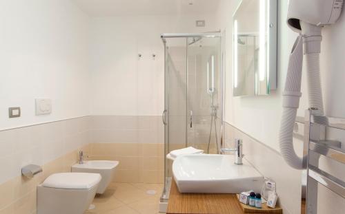 a bathroom with a toilet and a sink and a shower at Villa Angelina in Massa Lubrense