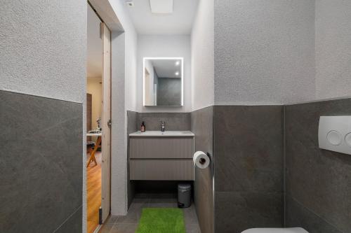 a bathroom with a sink and a mirror at Seaview apartments Refugium Krk in Polje