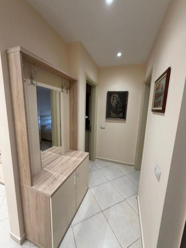 a bathroom with a large mirror and a tile floor at ApartHotel by Comfort Suites in Golem
