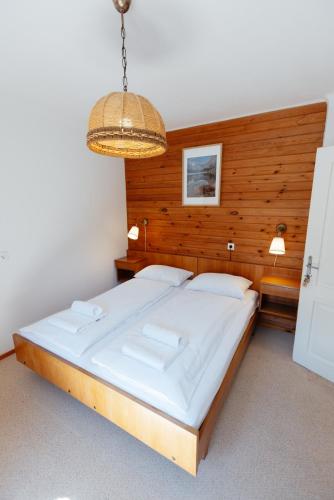 a bedroom with a large bed in a room at House Škantar Bohinj in Bohinj