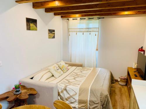 a bedroom with a bed in a room with wooden ceilings at Apartamentos Zabalarena Artzaia in Orbaiceta
