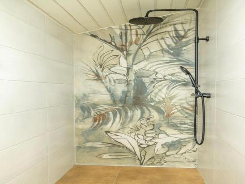 a shower in a bathroom with a painting on the wall at Ferienhof Mültner in Nordheim vor der Rhön