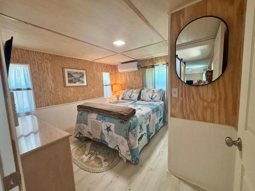 a small bedroom with a bed and a mirror at Prime Crystal River location! in Crystal River