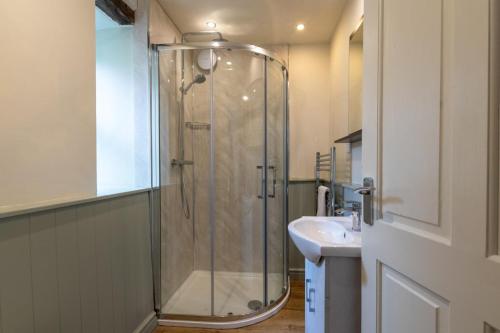 a bathroom with a shower and a sink at 1 Bed in Carmel oc-wai213 in Llanerchymedd