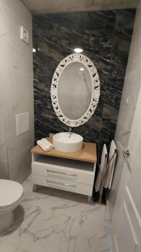 a bathroom with a sink and a mirror at Luxury Lighthouse Golf Apartment in Balchik