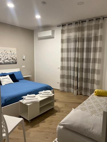 a bedroom with a blue bed and a couch at Midnight Sun in Vietri sul Mare