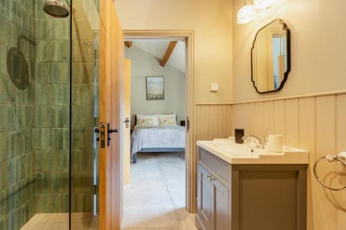 a bathroom with a shower and a sink and a mirror at 3 Bed in Wendron oc-w29093 in Wendron