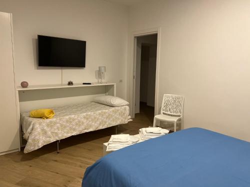 a bedroom with a bed and a tv on the wall at Midnight Sun in Vietri sul Mare