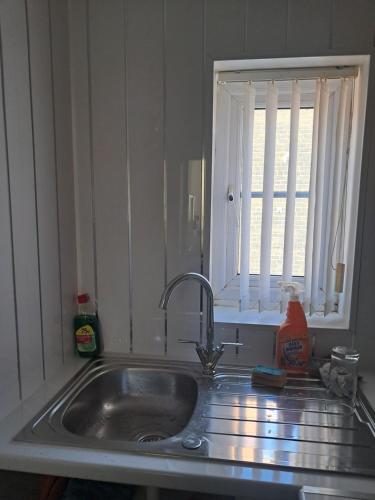 a kitchen counter with a sink and a window at Waterloo apartment in Middlesbrough