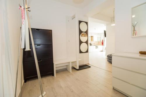 a kitchen with a black refrigerator in a room at Modern Studio near Old Town in Braşov
