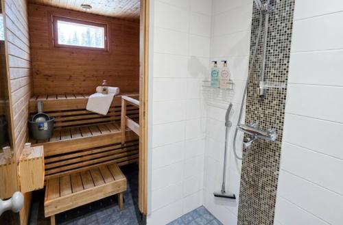 a bathroom with a sauna with a shower at Villa IRIS 4, Himos in Jämsä