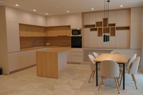 a large kitchen with a table and chairs at Complex SamElyon Residence in Samokov