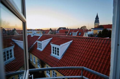 a view of a city with red roofs and a clock tower at Spacious House In Skagen in Skagen