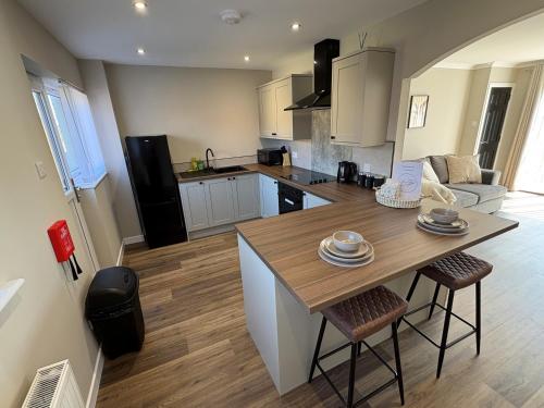 a kitchen with a large wooden table and chairs at Ladysford Lets - The Duck in Peterhead