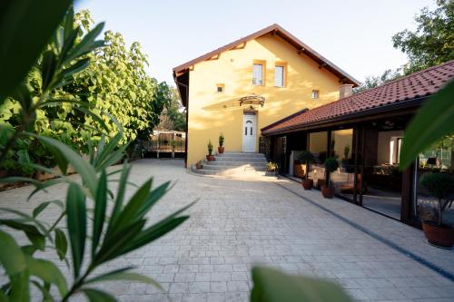 a building with a cobblestone street in front of it at Casa Mila in Belish
