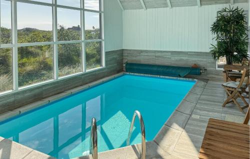 a swimming pool in a house with windows at Lovely Home In Saltum in Saltum