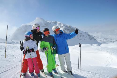 a group of people standing on top of a snow covered mountain at Le Roitelet in Châtel