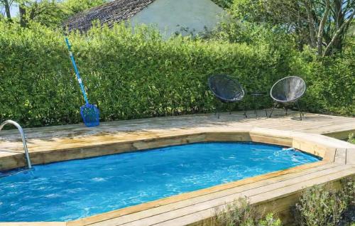 a swimming pool with two chairs and a mop at Stunning Home In Sæby in Sæby