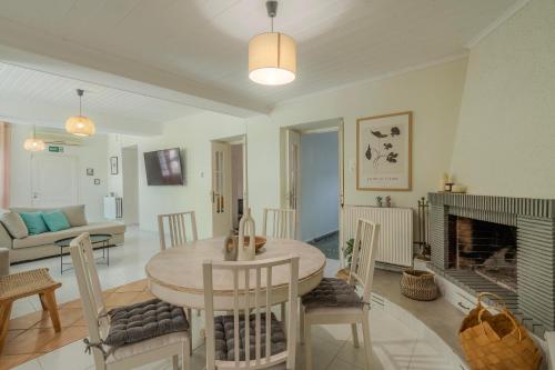a living room with a table and a fireplace at Joyful Secret Garden Residence Downtown by 8essentially in Chania