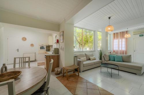 a living room with a couch and a table at Joyful Secret Garden Residence Downtown by 8essentially in Chania
