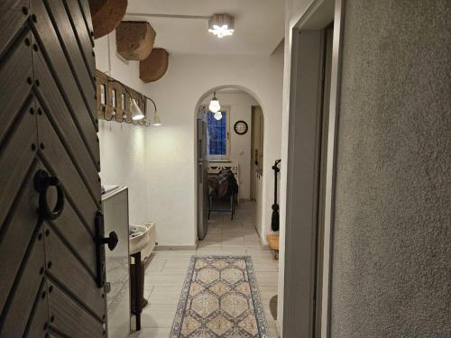 a hallway with a door and a room with a table at Ferienhaus Rathausgasse in Büdingen