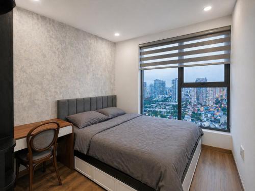 a bedroom with a bed and a desk and a window at JiL JiL homestay in Trạm Chánh An