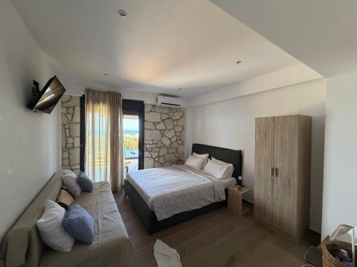 a bedroom with a bed and a large window at Afytos sea view in Afitos