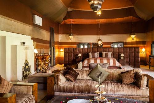 a bedroom with a large bed and a couch at PL Place Boutique Hôtel & Restaurant in Marrakesh