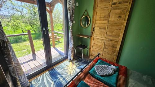 a room with a room with a large window at Calla Retreat in Vezenkovo