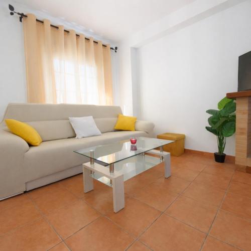 a living room with a couch and a coffee table at Mi Rincón Blanco in Grazalema