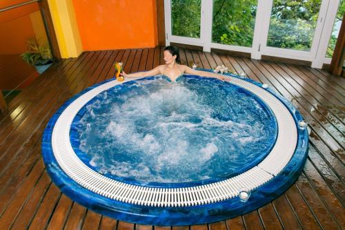 a man is laying in a swimming pool at Residence Bellevue in Tremosine Sul Garda